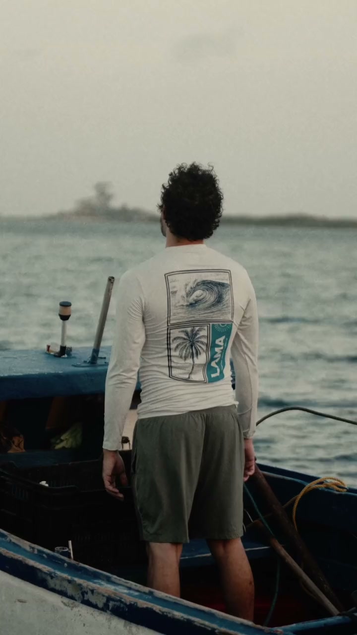 LAMA long-sleeve back graphic overlooking the sea from a fishing boat