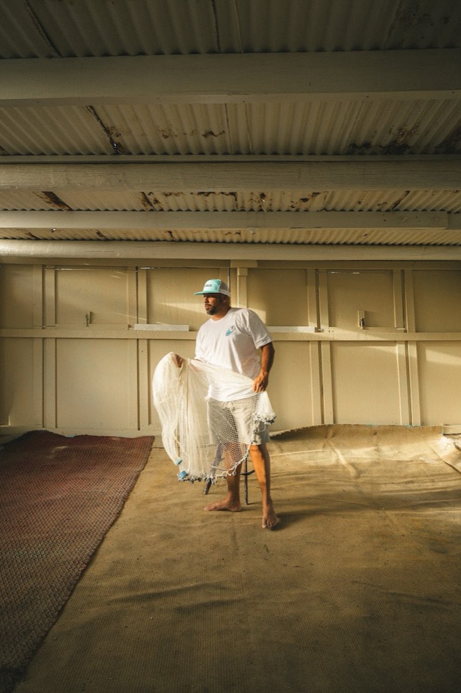 LAMA tee and cap photographed with fishing nets in Aruba