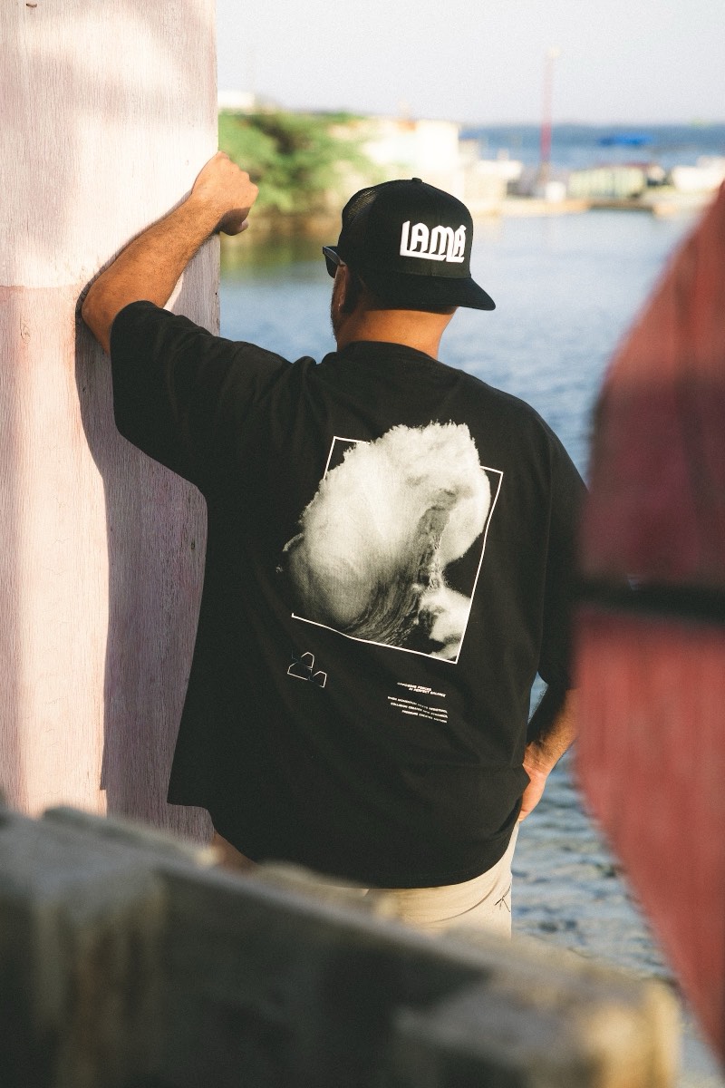 Black LAMA wave graphic tee overlooking the Caribbean Sea